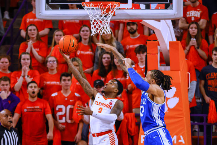 Clemson guard Al-Amir Dawes, left, shoots against Duke forward Theo John during the first half of an NCAA college basketball game in Clemson, S.C., Thursday, Feb. 10, 2022.